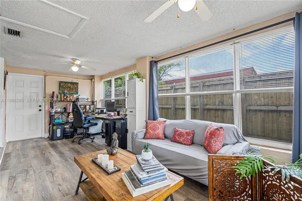 a living room with furniture and a large window