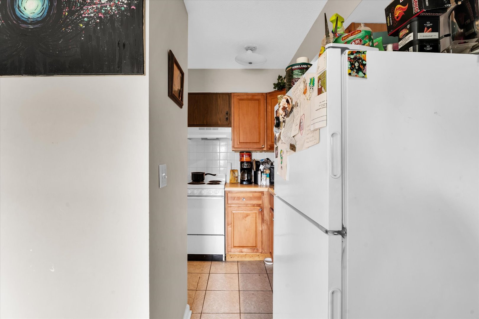 309 West Springfield Avenue Urbana, IL 61801 - Photo 11 of 35 a white refrigerator freezer and a stove sitting inside of a kitchen