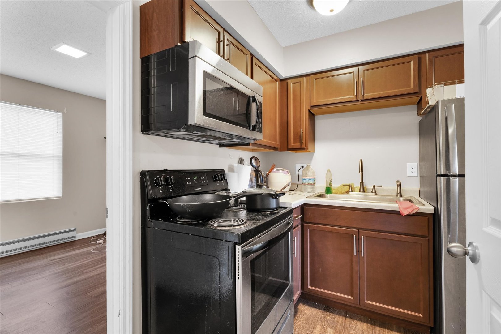 309 West Springfield Avenue Urbana, IL 61801 - Photo 24 of 35 a kitchen with stainless steel appliances granite countertop a sink stove and microwave