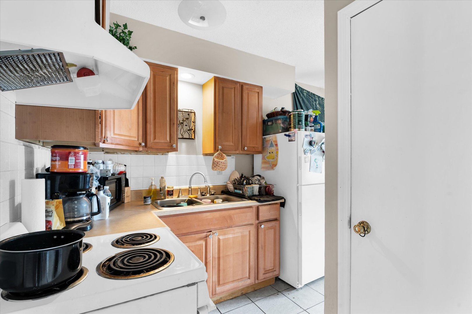309 West Springfield Avenue Urbana, IL 61801 - Photo 10 of 35 a kitchen with a stove a refrigerator and a sink