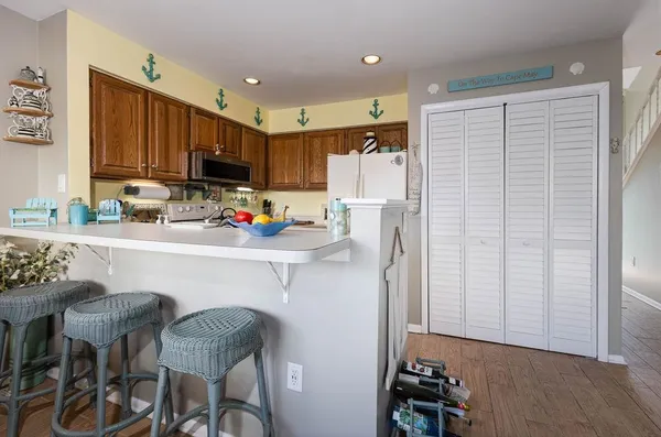 a kitchen with granite countertop a sink a stove and cabinets
