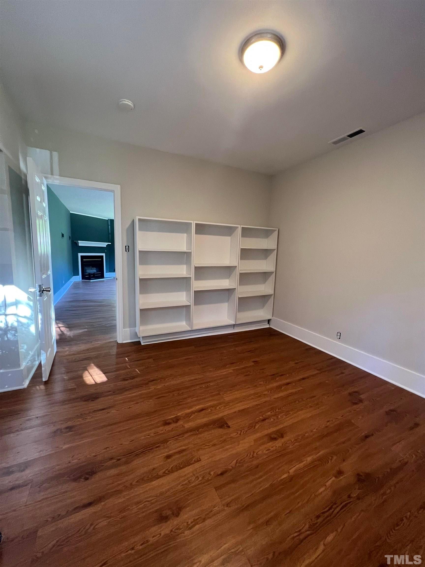913 Brookwood Drive Raleigh, NC 27607 - Photo 15 of 26 a view of a room with wooden floor