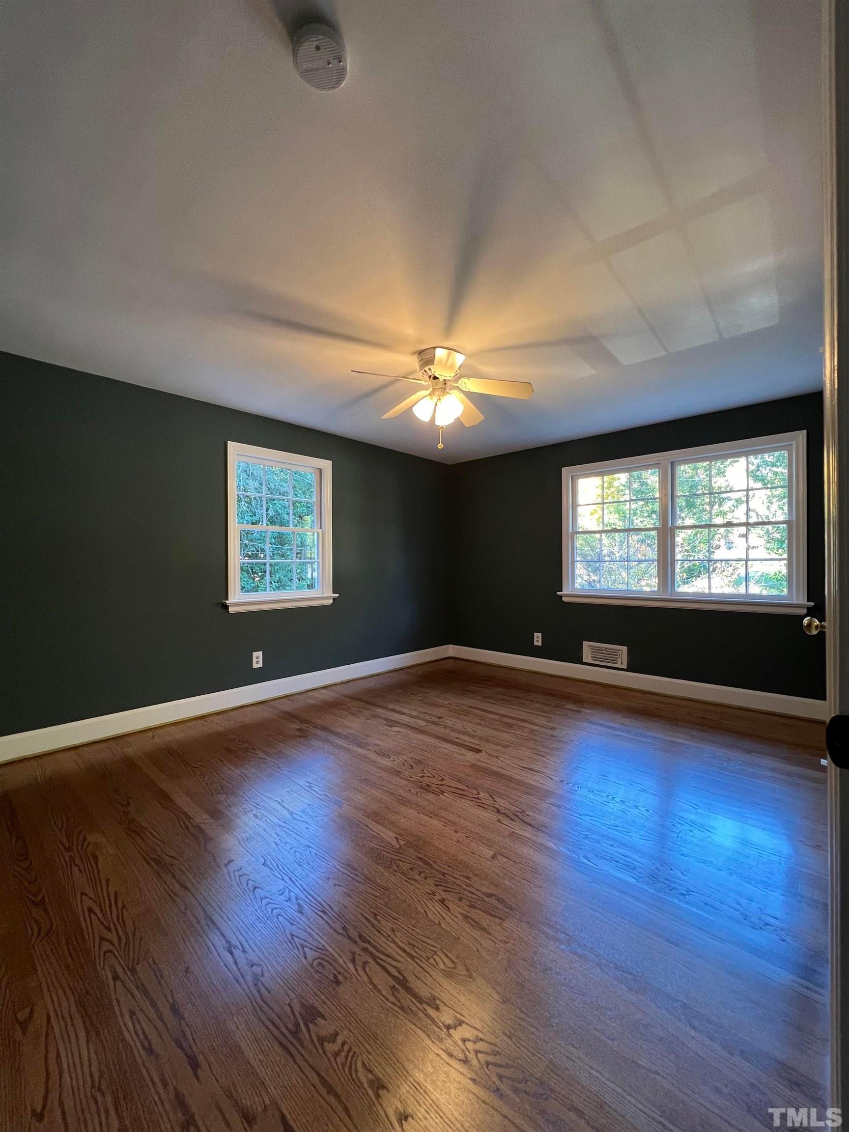 913 Brookwood Drive Raleigh, NC 27607 - Photo 18 of 26 a view of empty room with wooden floor and fan