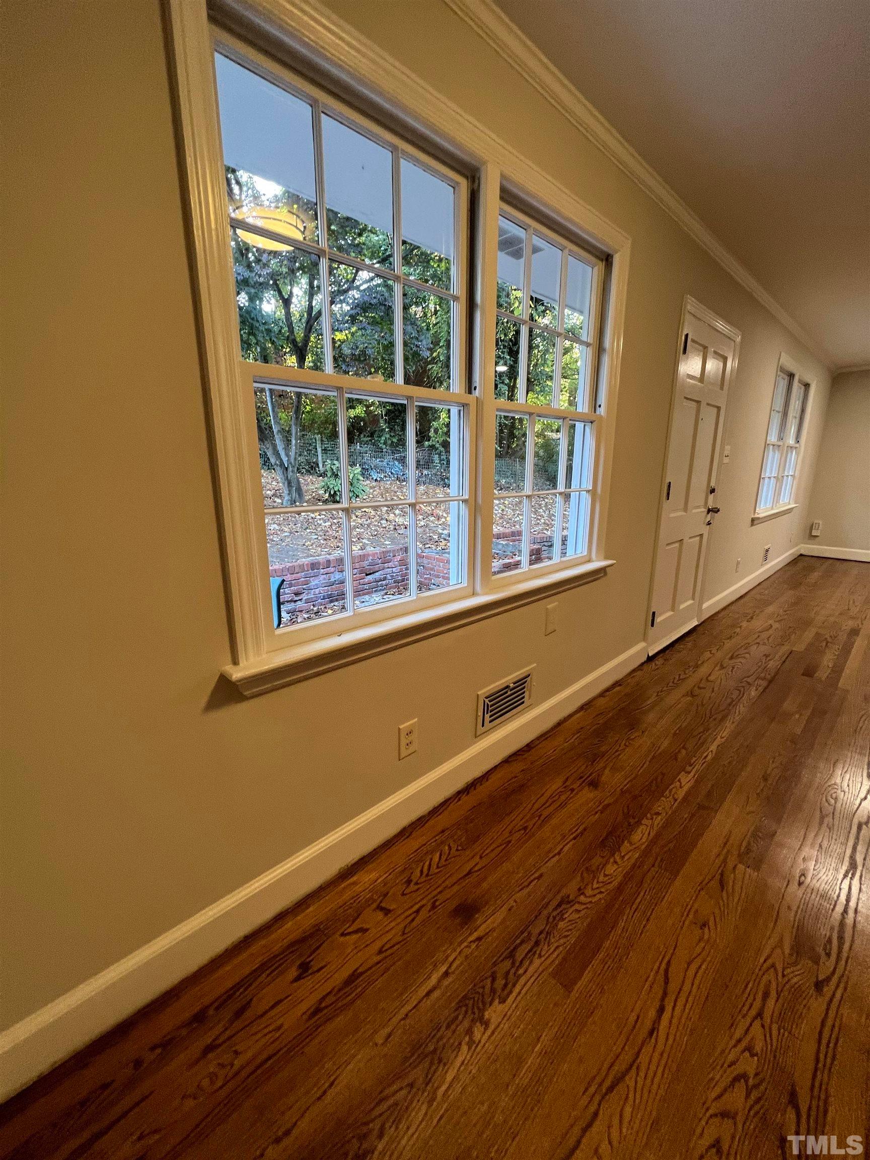 913 Brookwood Drive Raleigh, NC 27607 - Photo 22 of 26 a view of a room with wooden floor and windows