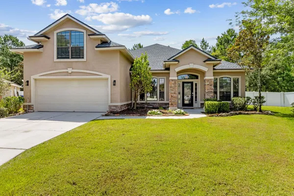 a front view of house with yard and green space