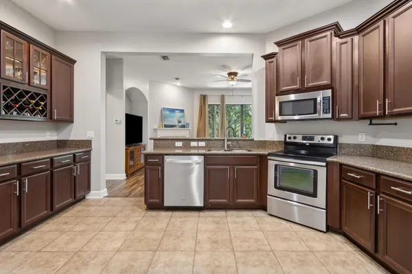 a kitchen with stainless steel appliances granite countertop a refrigerator and a stove top oven