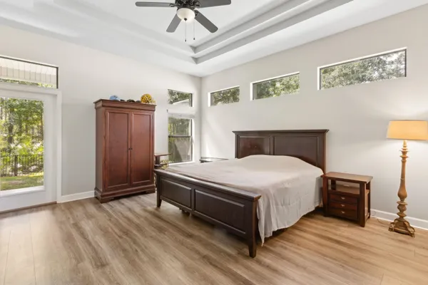 a spacious bedroom with a bed and a flat screen tv