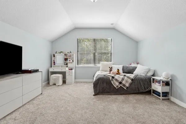 a bedroom with a bed and a lamp