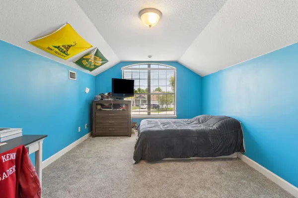 a bedroom with furniture and a window