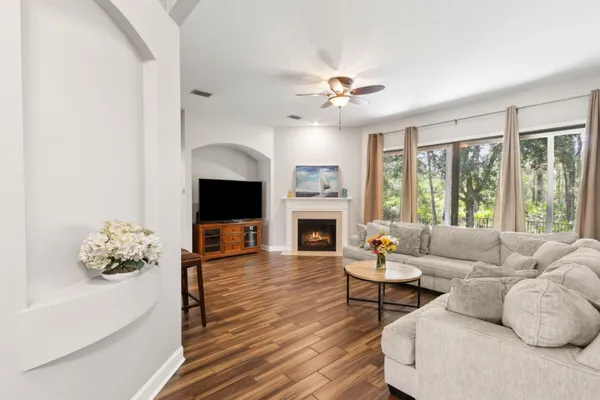 a living room with furniture a fireplace and a flat screen tv