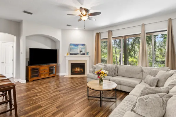 a living room with furniture a flat screen tv and a fireplace