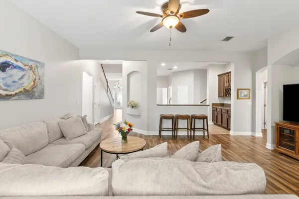 a living room with furniture wooden floor and a flat screen tv