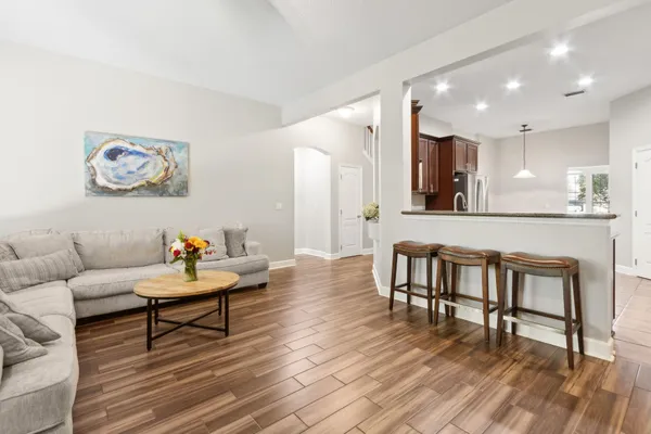 a living room with furniture and a wooden floor