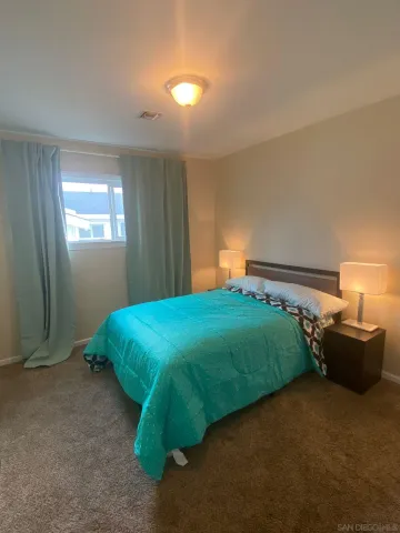 a bedroom with a bed and window