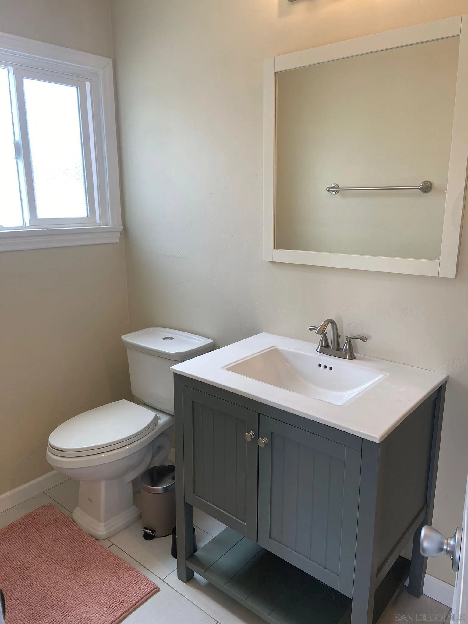 5442 San Onofre Terrace San Diego, CA 92114 - Photo 14 of 29 a bathroom with a sink toilet and mirror