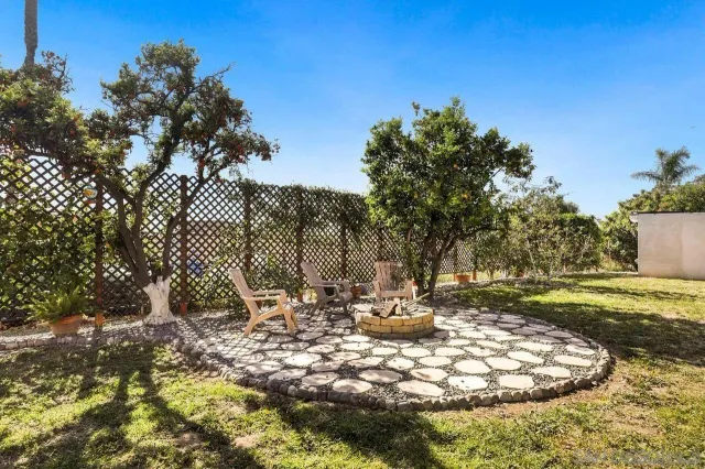 a view of a backyard with wooden fence