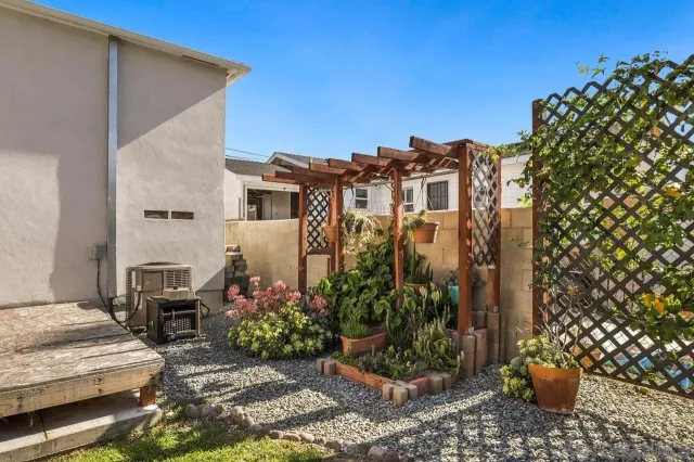 a view of a patio with plants and chairs