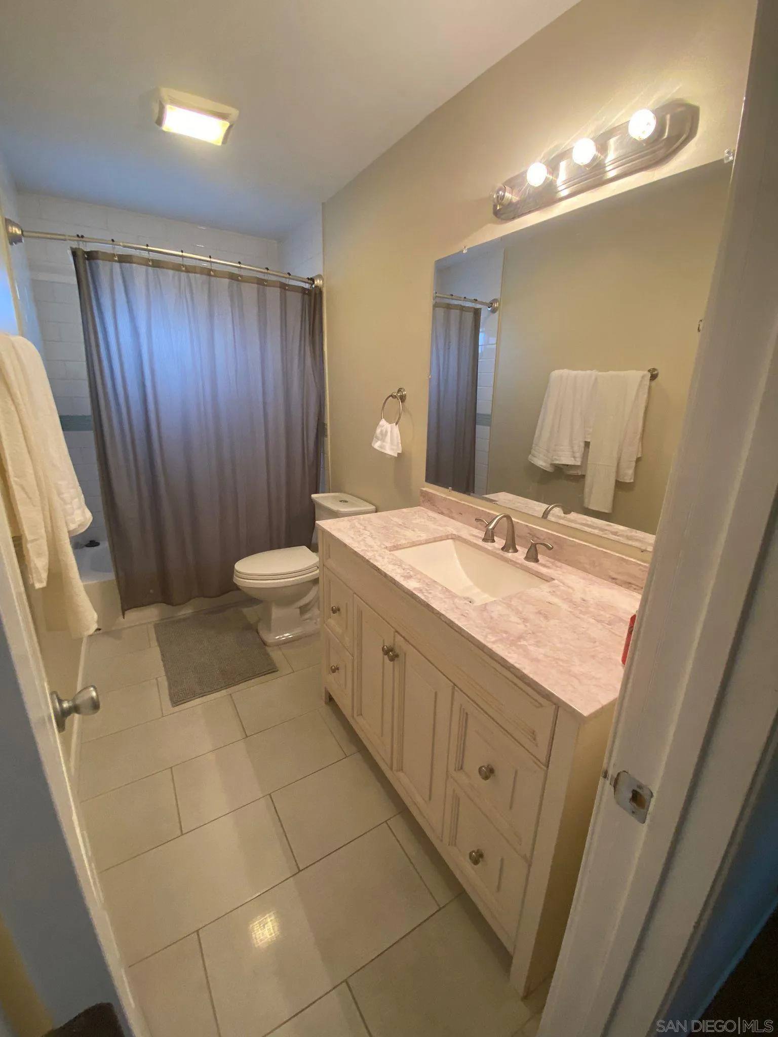 5442 San Onofre Terrace San Diego, CA 92114 - Photo 24 of 29 a spacious bathroom with a granite countertop sink a toilet and mirror
