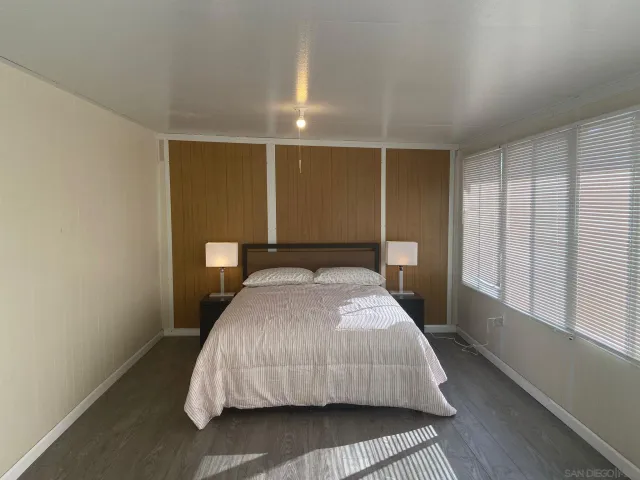 a bedroom with a bed and window