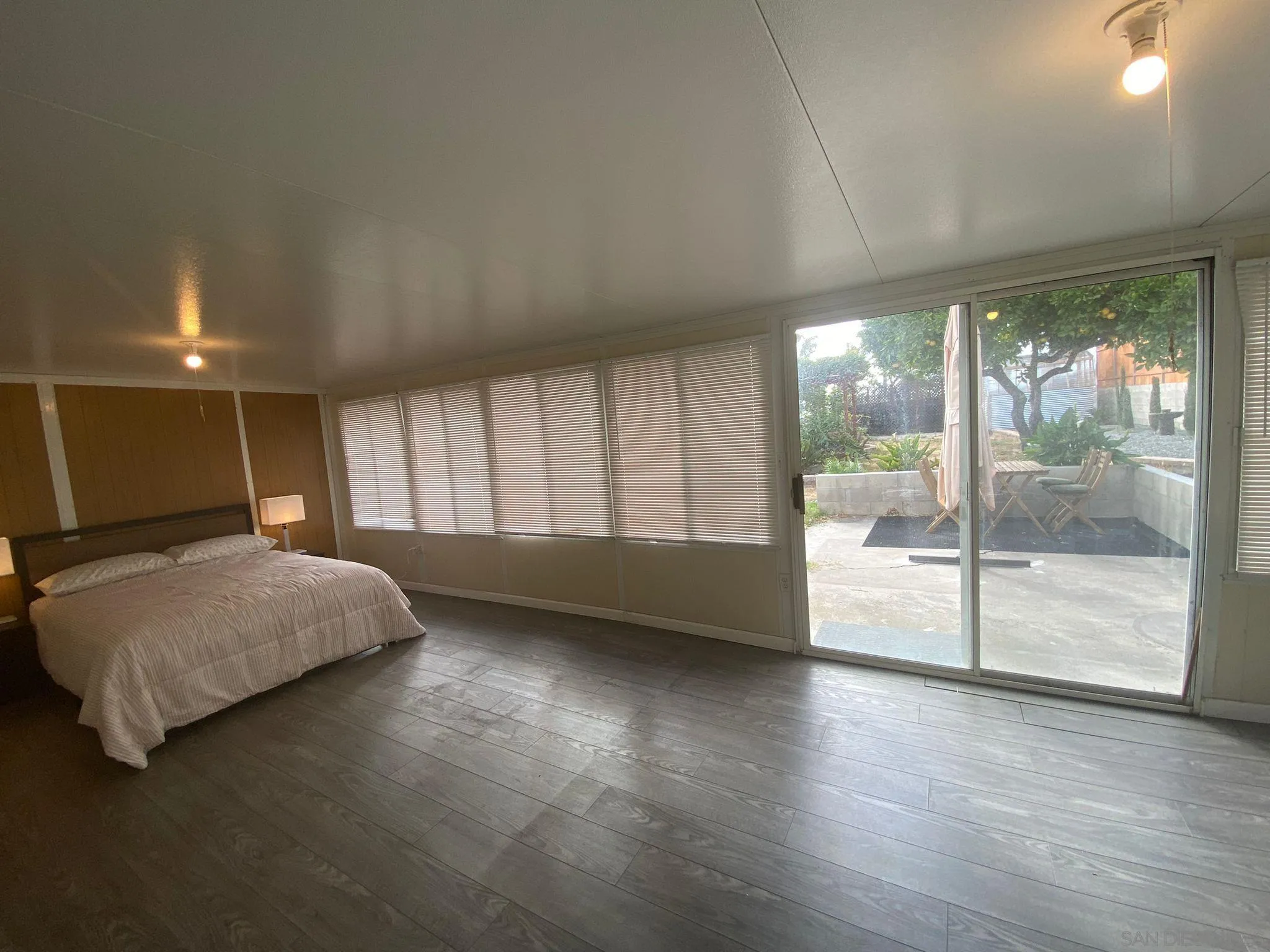 5442 San Onofre Terrace San Diego, CA 92114 - Photo 28 of 29 a spacious bedroom with a balcony a bed and a large window