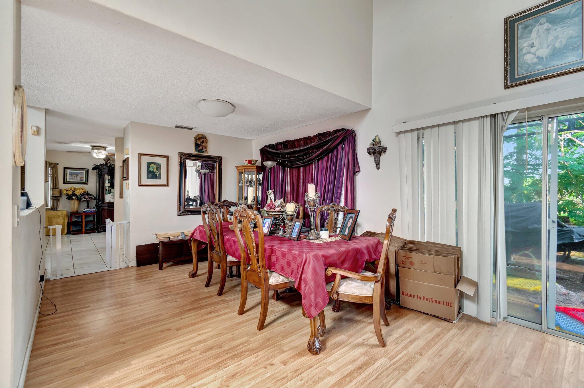8557 Windy Circle Boynton Beach, FL 33472 - Photo 5 of 11 a view of a dining room with furniture and wooden floor