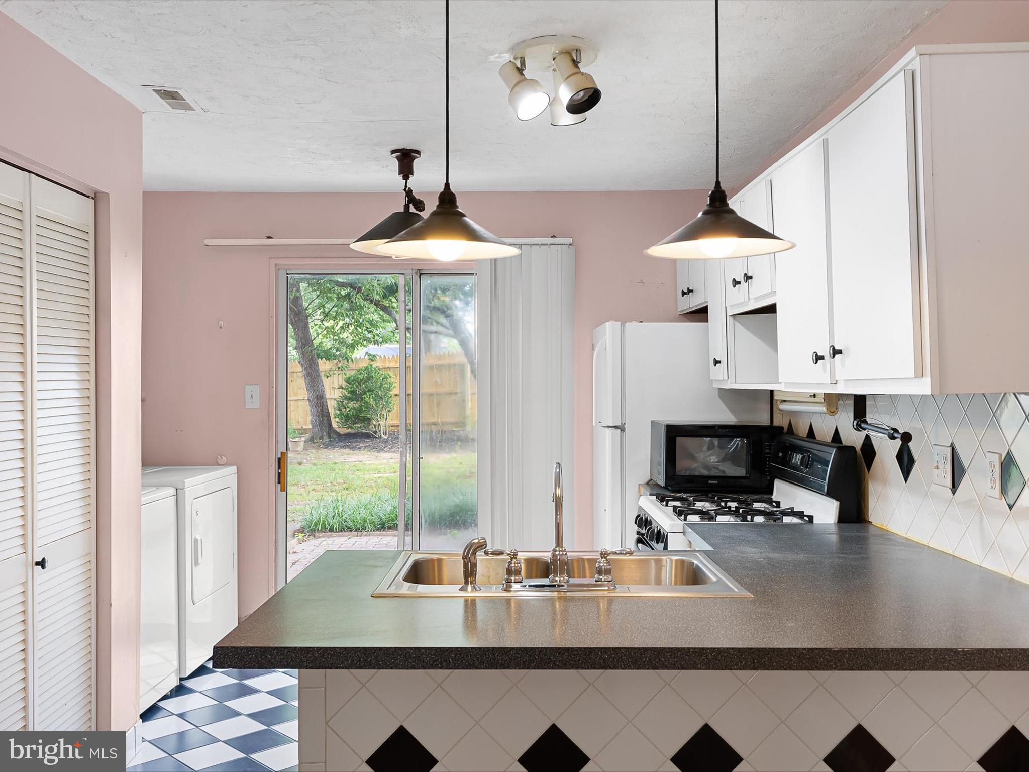 5 Topaz Drive Newark, DE 19702 - Photo 9 of 28 a kitchen with a table chairs a stove and a window
