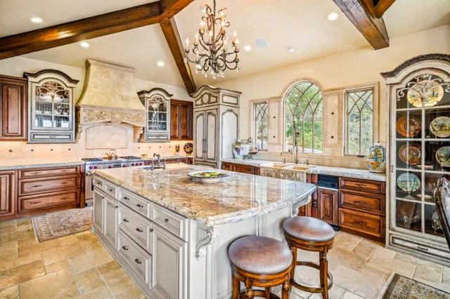 a bathroom with a granite countertop sink a mirror and a bathtub
