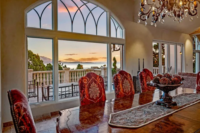 a spacious bathroom with a granite countertop double vanity sink a mirror a bathtub and next to a window