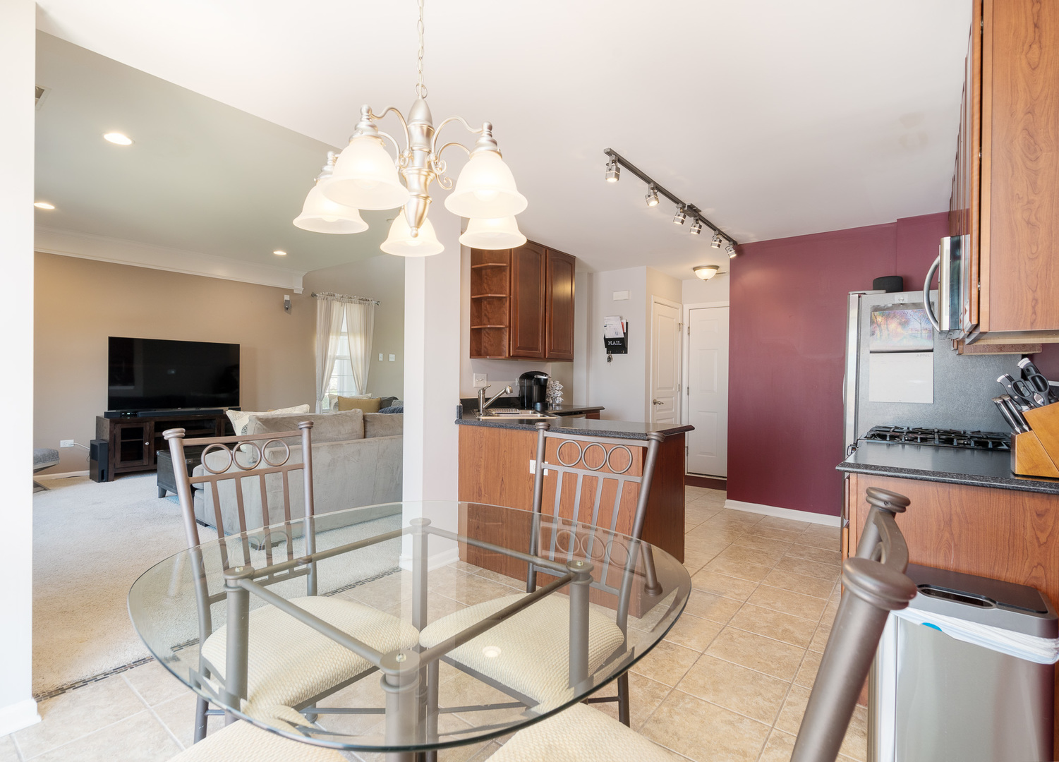 15316 Pinewood Road Lockport, IL 60441 - Photo 11 of 31 a view of a dining room with furniture and a flat screen tv