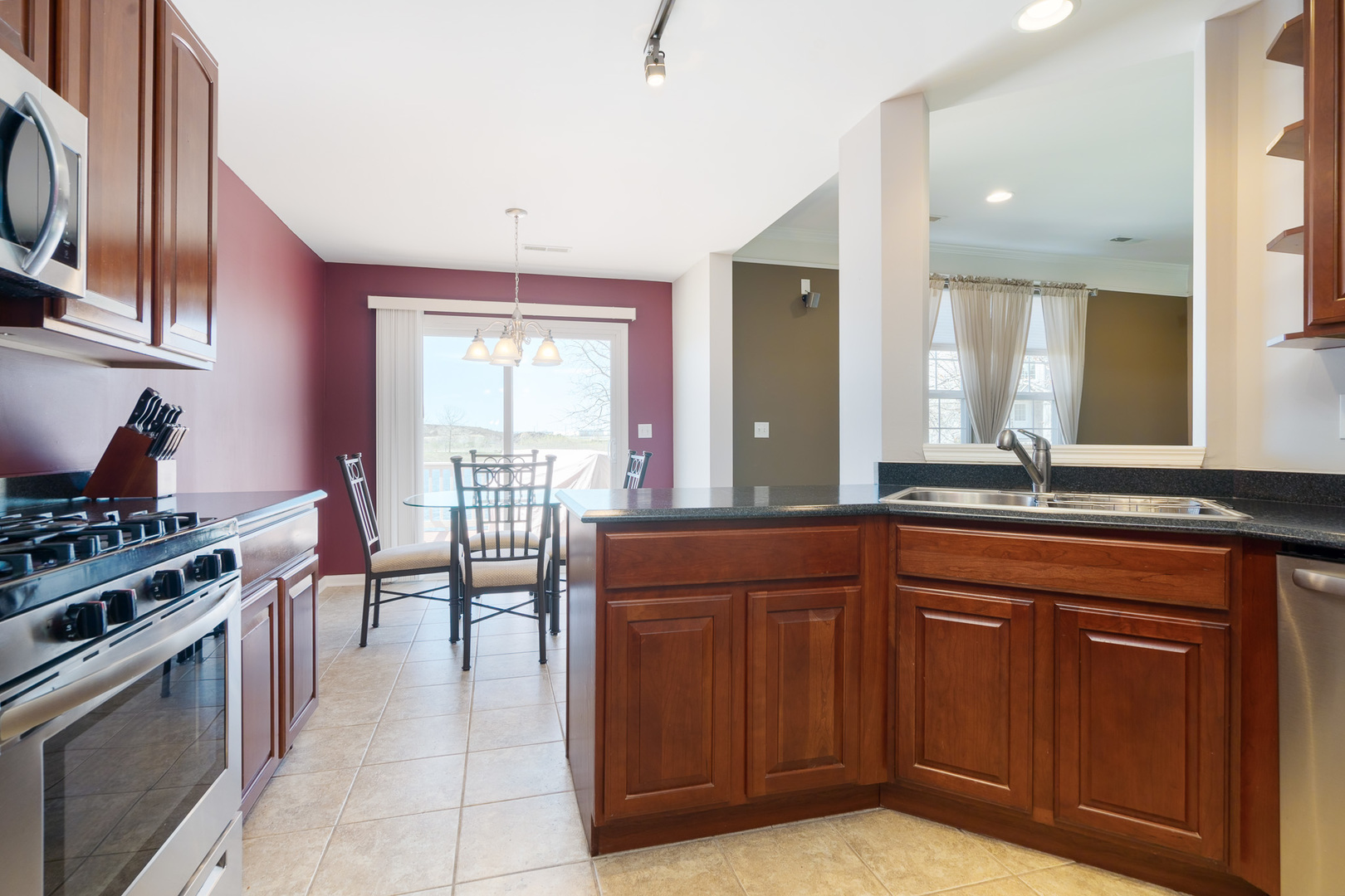 15316 Pinewood Road Lockport, IL 60441 - Photo 8 of 31 a kitchen with stainless steel appliances granite countertop a stove a sink and a microwave