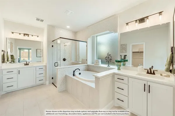 a bathroom with a tub a sink double vanity and a mirror