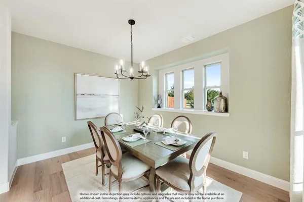 a view of a dining room with a table and chairs
