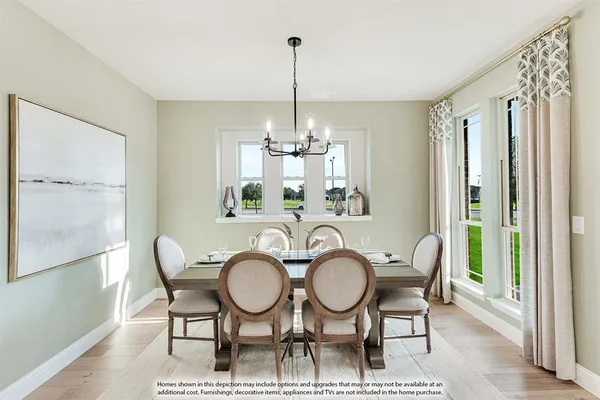 a living room with furniture a rug and a chandelier