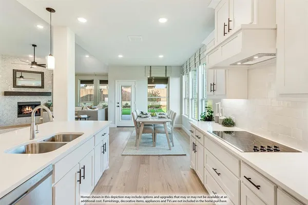 a large kitchen with stainless steel appliances lots of counter space and a sink