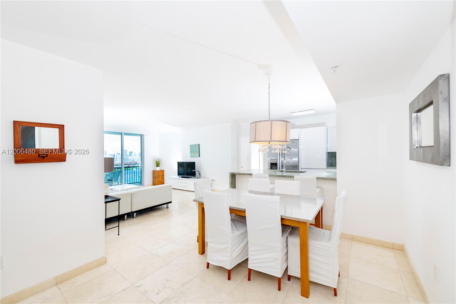 a large living room with stainless steel appliances kitchen island granite countertop furniture and a living room