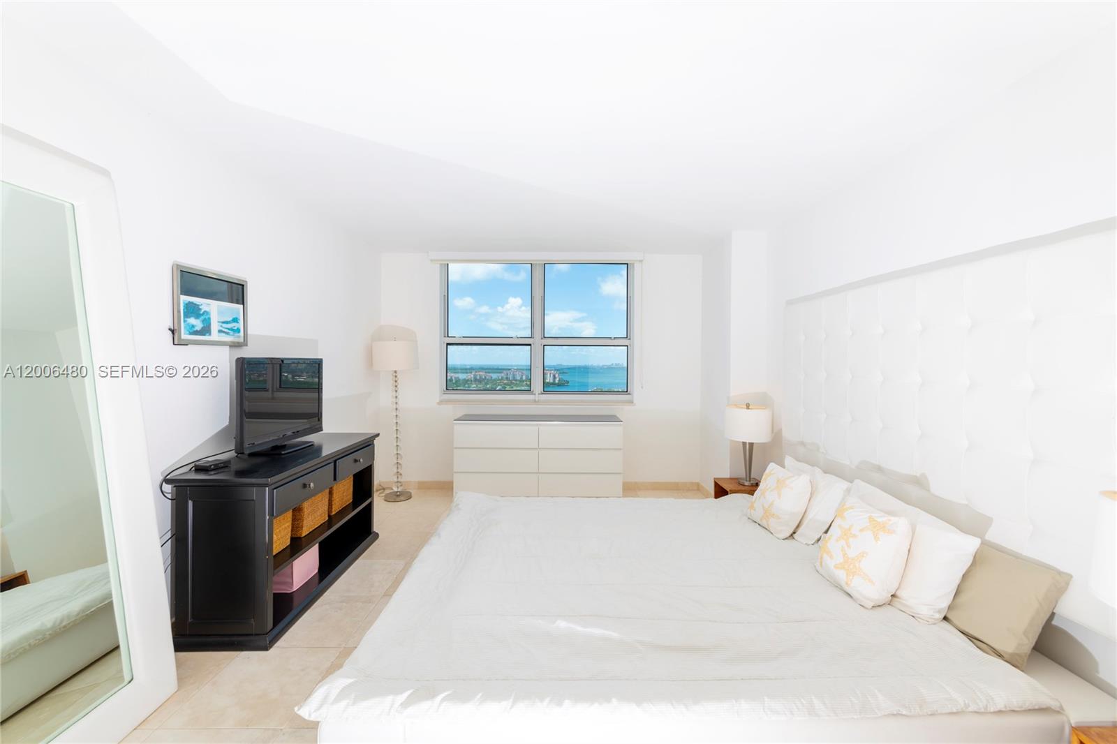90 Alton Road, Unit 2304 Miami Beach, FL 33139 - Photo 11 of 16 a bedroom with a bed and a window