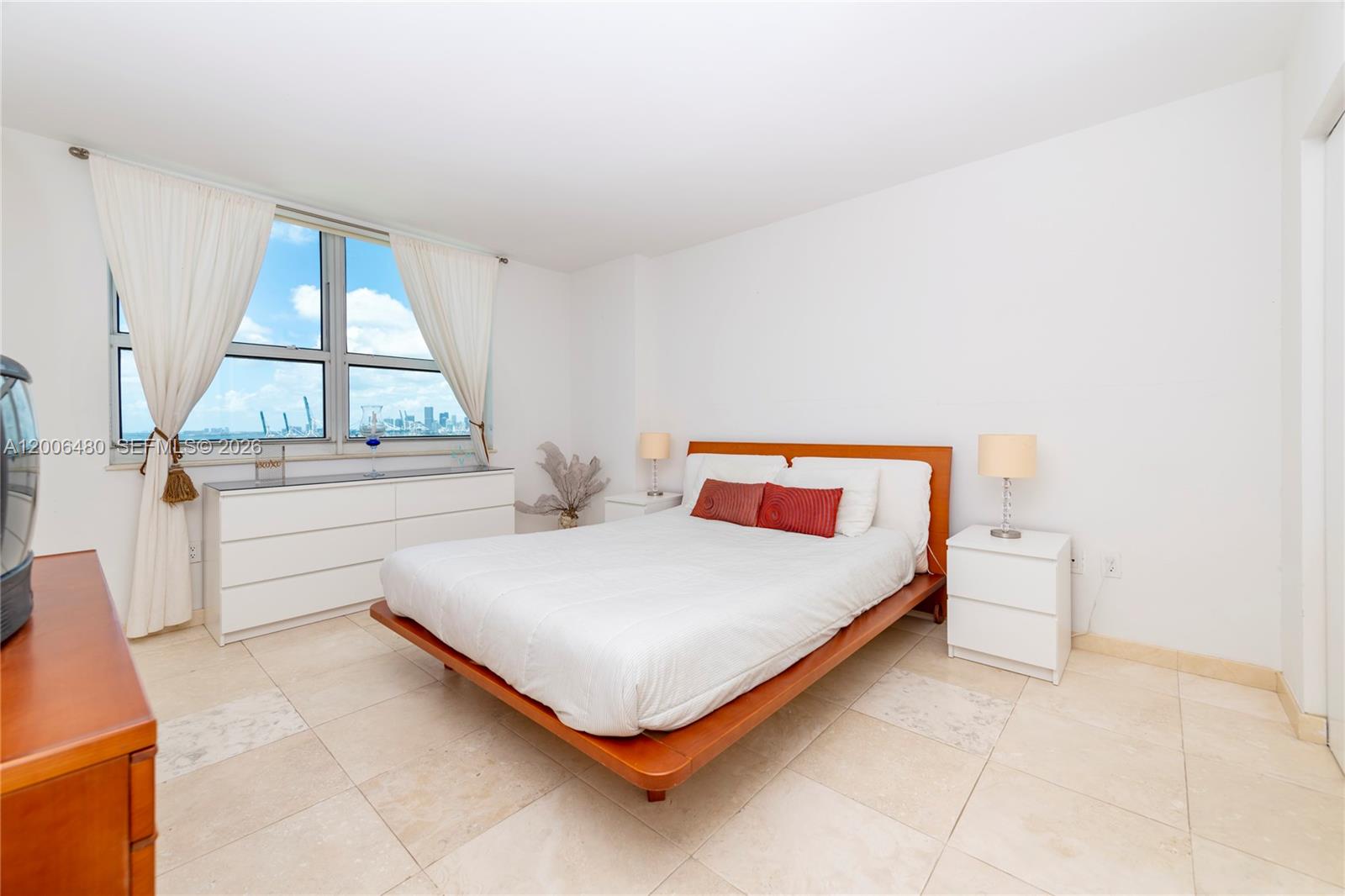 90 Alton Road, Unit 2304 Miami Beach, FL 33139 - Photo 14 of 16 a bedroom with a bed and a window