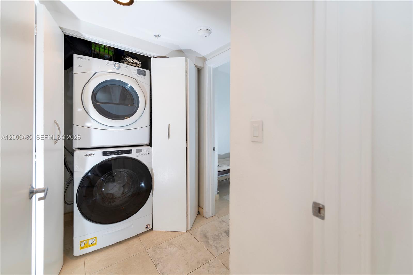 90 Alton Road, Unit 2304 Miami Beach, FL 33139 - Photo 15 of 16 a view of a hallway with washer and dryer