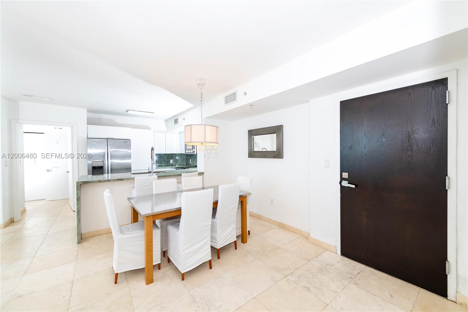 90 Alton Road, Unit 2304 Miami Beach, FL 33139 - Photo 2 of 16 a living room with stainless steel appliances kitchen island granite countertop furniture and a refrigerator