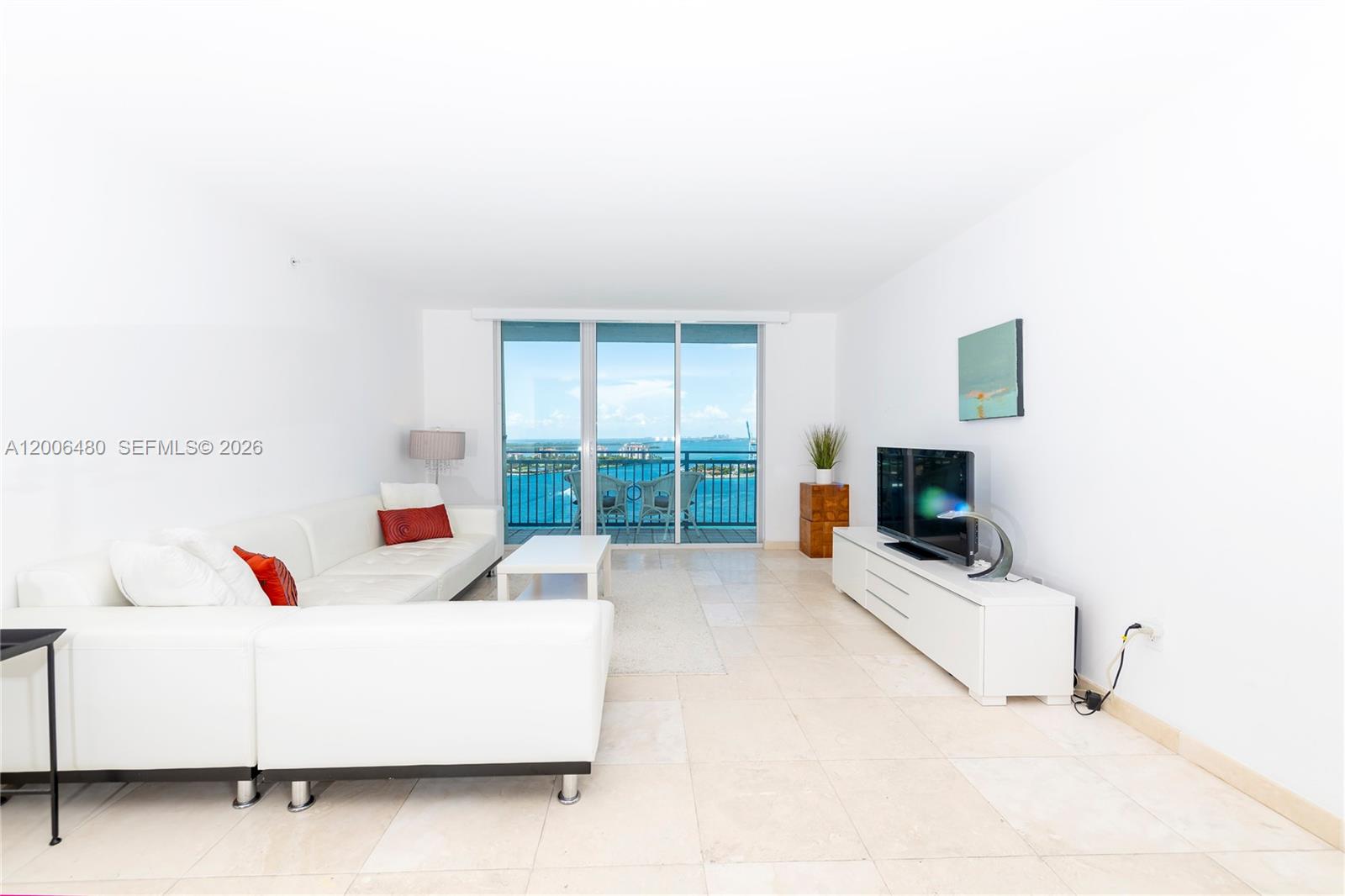 90 Alton Road, Unit 2304 Miami Beach, FL 33139 - Photo 7 of 16 a living room with furniture and a flat screen tv