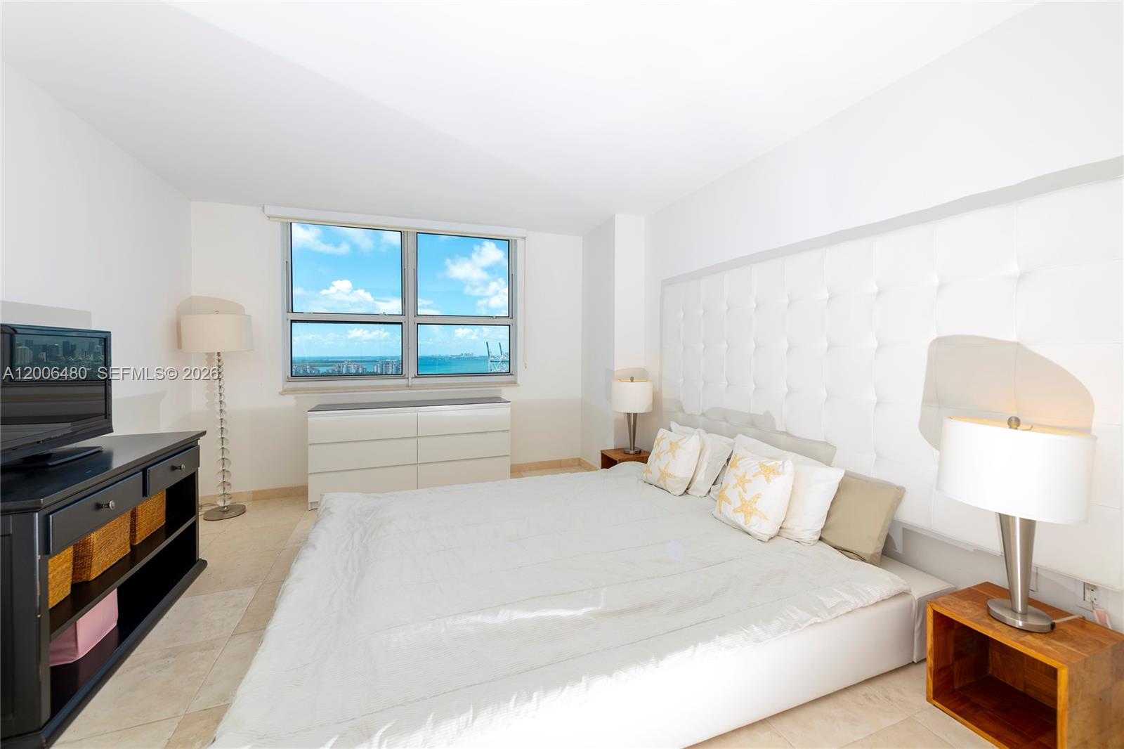 90 Alton Road, Unit 2304 Miami Beach, FL 33139 - Photo 10 of 16 a bedroom with a bed and a fireplace