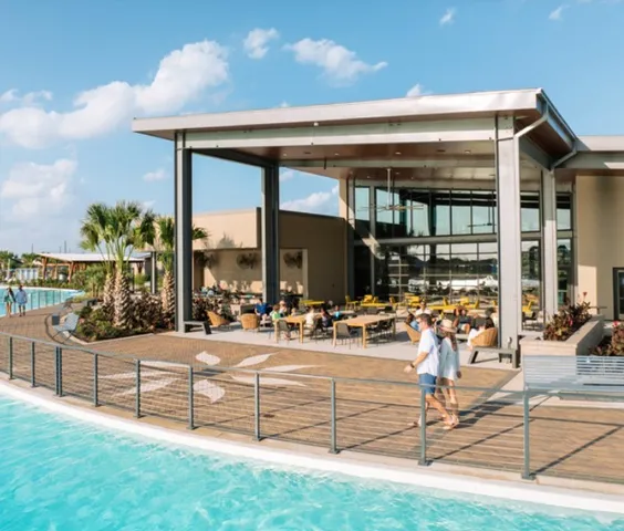 a living room with patio furniture and garden view