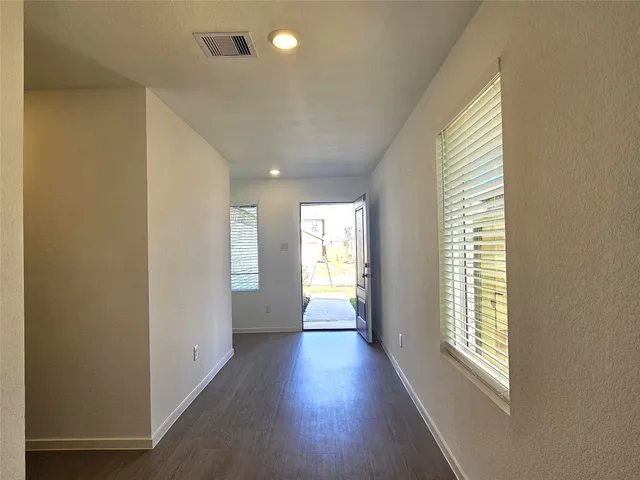 a view of hallway with wooden floor and staircase