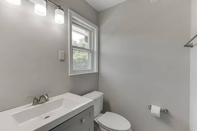 a white toilet sitting next to a bath tub