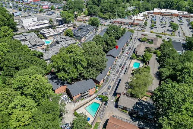 an aerial view of multiple houses with yard