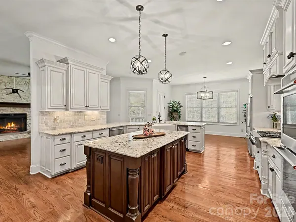 a kitchen with stainless steel appliances granite countertop a stove and a sink