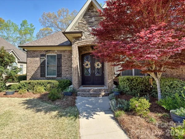 a front view of a house with garden
