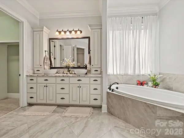 a bath tub sitting in a bathroom next to a sink
