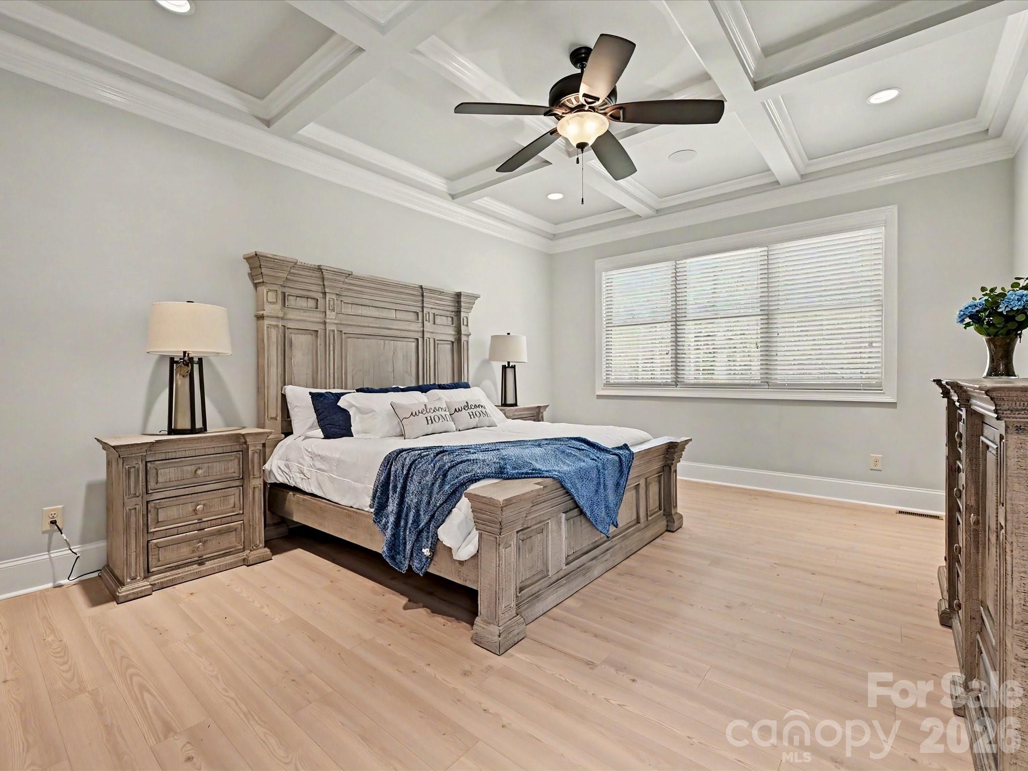 280 Palm Cove Way York, SC 29745 - Photo 26 of 48 a spacious bedroom with a large bed a chandelier and windows