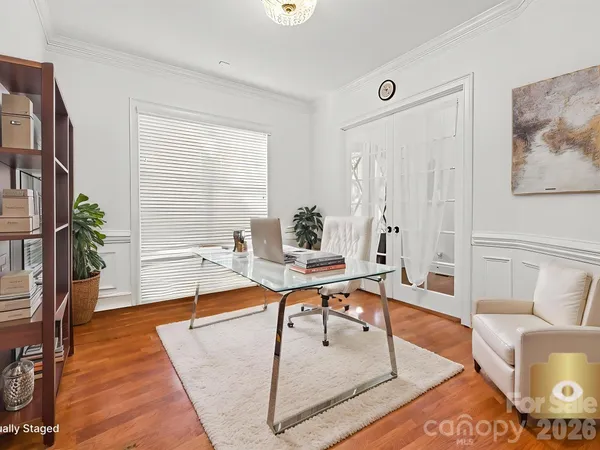 a living room with furniture a table and a potted plant